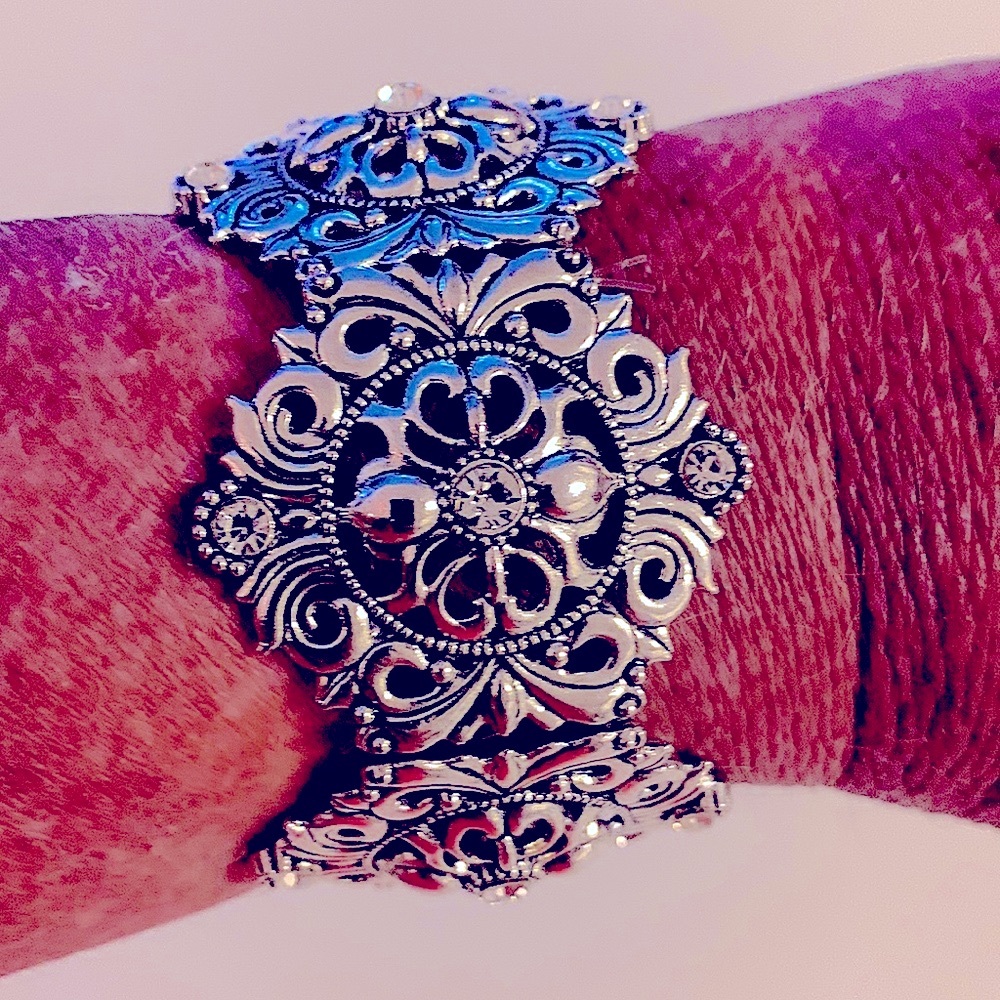 Handcrafted silver bangle bracelet with clear rhinestones and filigree design